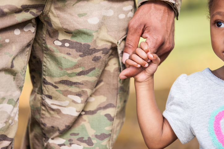 military child holding hand